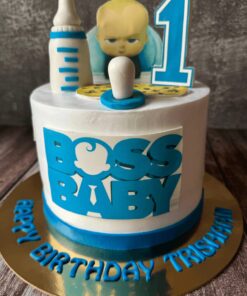 Boss Baby Theme Birthday Cake by Sweet Cakery Bangalore featuring cream finish, baby figurine topper, milk bottle, pacifier, and number 1 design.