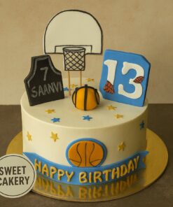 Basketball theme birthday cake from Sweet Cakery with fondant hoop, jersey, ball and star decorations in a sports theme design.