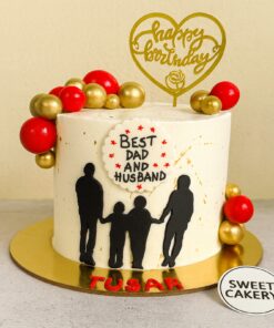 A professionally designed Best Dad and Husband birthday cake by Sweet Cakery Bangalore, decorated with red and gold edible balls, cream finish, and family silhouette theme.