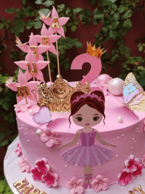 Birthday cake with princess doll, crown, butterflies and custom name in pink theme