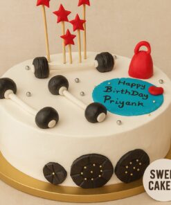Gym lover birthday cake by Sweet Cakery in Bangalore with edible dumbbells, kettlebell, red stars, and cream finish, perfect for fitness enthusiasts.