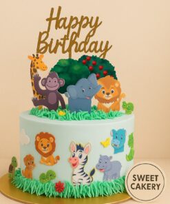 Sweet Cakery jungle theme birthday cake with animal decorations, cream icing, green grass details, and playful toppers for kids’ celebration