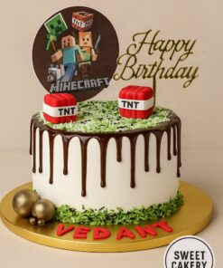 Minecraft theme cake by Sweet Cakery with chocolate drip, fondant TNT blocks, green grass icing, gold Happy Birthday topper, and custom name on board