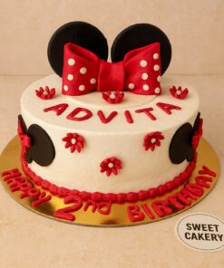 Minnie Mouse theme birthday cake by Sweet Cakery featuring red bow, Minnie ears, and floral decorations, custom cake for young girls in Bangalore