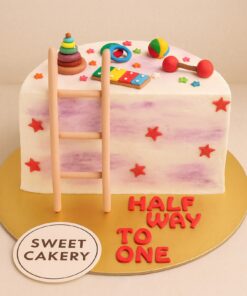 Sweet Cakery six month birthday cake with colourful toy decorations, stars, and cream finish, custom kids theme cake in Bangalore