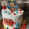 High-quality photo of a Spiderman theme birthday cake from Sweet Cakery, decorated with Spiderman topper, web details, red and blue stars, and comic elements.
