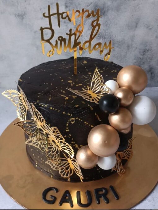 Golden butterfly and balloon cake