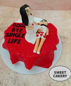 Fondant couple cake featuring a playful bride and groom topper from Sweet Cakery, ideal for bachelor and bachelorette celebrations in Bangalore.