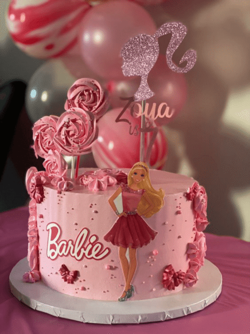 Barbie birthday cake with pink buttercream roses, Barbie doll cutout, and glitter silhouette topper