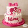 Two-tier Barbie birthday cake with pink silhouette, bows, hearts, and custom name