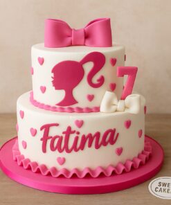 Two-tier Barbie birthday cake with pink silhouette, bows, hearts, and custom name