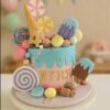 Candy-themed birthday cake with pastel fondant candies, ice creams, lollipops