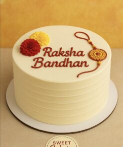 Raksha Bandhan special cake with handcrafted rakhi and marigold flowers, eggless festive cake by Sweet Cakery Bangalore