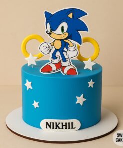 Sonic theme birthday cake in blue fondant with Sonic topper, yellow rings and white stars