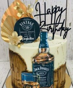 Round whiskey-themed birthday cake with Jack Daniel’s bottle and gold fan topper – adult cake design by Sweet Cakery Bangalore