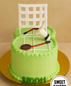 Badminton theme birthday cake by Sweet Cakery, showing a green court design with rackets, shuttle, and net. Sports themed custom cake in Bangalore.