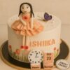 Sweet Cakery birthday cake for young girls with fondant doll in peach dress, butterfly, floral decorations, birthday blocks