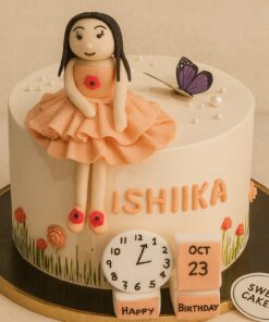 Sweet Cakery birthday cake for young girls with fondant doll in peach dress, butterfly, floral decorations, birthday blocks