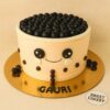 Cute boba tea theme birthday cake by Sweet Cakery with black boba pearls, smiling fondant face. 100% eggless, Bangalore.
