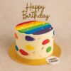 Colourful rainbow theme birthday cake from Sweet Cakery with cream finish, rainbow stripes, brushstroke details, gold accents, and topper.