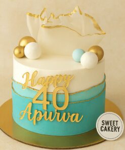 Elegant 40th birthday cake from Sweet Cakery with cream icing, gold sugar sail, decorative fondant spheres and modern blue design.