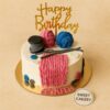 Knitting theme birthday cake with fondant yarn balls, wool texture, buttons and knitting needles, crafted by Sweet Cakery in Bangalore.