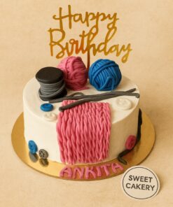 Knitting theme birthday cake with fondant yarn balls, wool texture, buttons and knitting needles, crafted by Sweet Cakery in Bangalore.