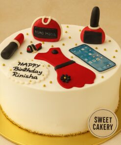 Round fashion-themed birthday cake for teenager girl with red fondant dress, lipstick, smartphone