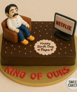 Netflix inspired dad birthday cake by Sweet Cakery in Bangalore featuring fondant dad figure, Netflix TV screen, gold pearls, and cream finish.