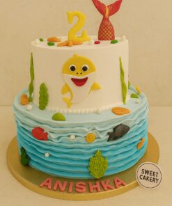 Underwater Baby Shark birthday cake with cream finish, fondant sharks, ocean waves, colourful fish, shells