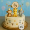 A 9 months birthday cake from Sweet Cakery featuring a cute jungle theme with monkey, giraffe, and elephant toppers in a party-style design.