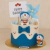 Doraemon theme birthday cake from Sweet Cakery with blue and white icing, cartoon figures, bow, and topper, ideal for kids’ celebrations