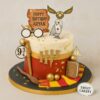 Harry Potter theme birthday cake featuring an owl, Golden Snitch, and Hogwarts elements, from Sweet Cakery Bangalore.