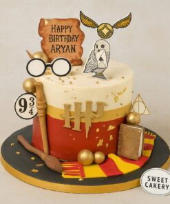 Harry Potter theme birthday cake featuring an owl, Golden Snitch, and Hogwarts elements, from Sweet Cakery Bangalore.