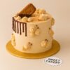 Lotus Biscoff themed cake with biscuit topping, chocolate drip, and whipped cream details from Sweet Cakery Bangalore