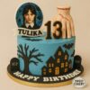 Spooky Wednesday Addams themed birthday cake with haunted house, bats, stitched hand topper, and custom topper by Sweet Cakery Bangalore