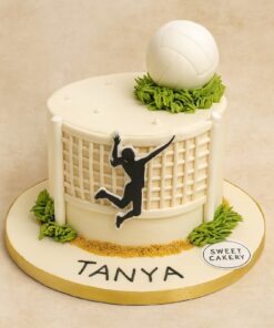 Volleyball-themed birthday cake for girls from Sweet Cakery featuring a fondant volleyball, player silhouette, and realistic net decoration.